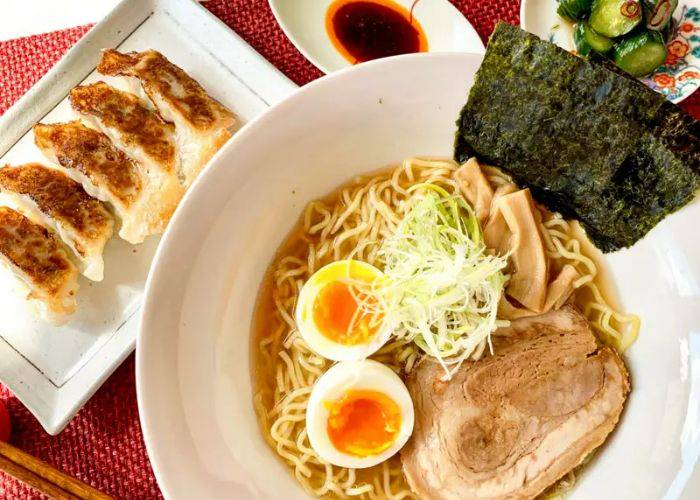 A top-down shot of ramen and gyoza at a cooking class in Kyoto.